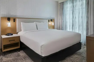 a large white bed in a room with a window at Residence Inn by Marriott Chatsworth in Chatsworth