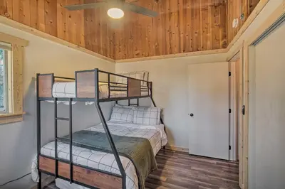 a bedroom with a bunk bed and a ceiling at Newly Renovated Lake Arrowhead Cabin with Deck! in Lake Arrowhead