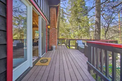 a wooden porch of a house with a door at Newly Renovated Lake Arrowhead Cabin with Deck! in Lake Arrowhead