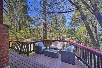 a deck with two chairs and a table and chairs at Newly Renovated Lake Arrowhead Cabin with Deck! in Lake Arrowhead