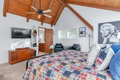 a bedroom with a bed and a ceiling fan at Serene Cabin in Lake Arrowhead