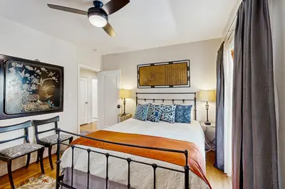 a bedroom with a bed and a ceiling fan at Cedar Oasis in Ventura