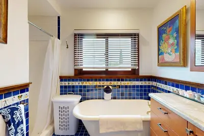a blue tiled bathroom with a tub and a sink at Highland Park Haven in Los Angeles