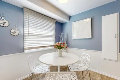 a dining room with a white table and chairs at Evening Oasis in Orange