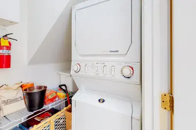 a white refrigerator with a washer and dryer at Tree-Top Getaway in Lake Arrowhead