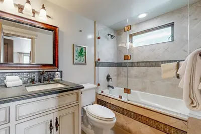 a bathroom with a toilet and a sink and a tub at Breakers Way Adventure in Carpinteria