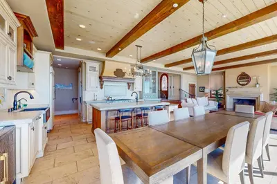a large kitchen with a wooden table and chairs at Breakers Way Adventure in Carpinteria