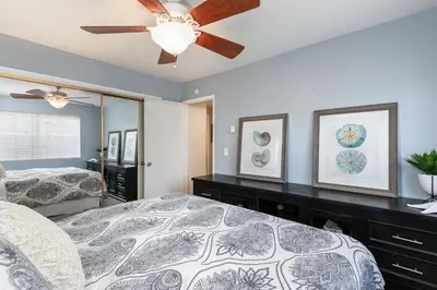 a bedroom with a bed and a ceiling fan at Sunset Palace in Hermosa Beach