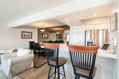 a kitchen and living room with a bar and a couch at Sunset Palace in Hermosa Beach