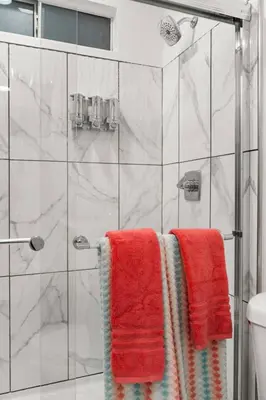 a bathroom with red towels on a shower at The Avalon - 35 Percent Off March! in Los Angeles