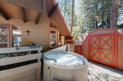 a large hot tub in a cabin with a red gate at Annandale Manor in Lake Arrowhead