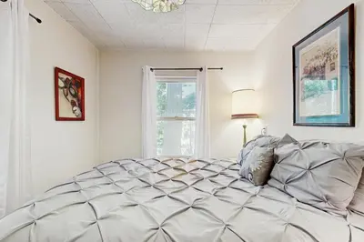 a large bed in a room with a window at The Cottage in Lake Arrowhead