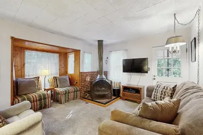 a living room with a couch and a fireplace at The Cottage in Lake Arrowhead