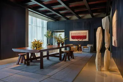 a dining room with a wooden table and a couch at AC Hotel by Marriott Downtown Los Angeles in Los Angeles