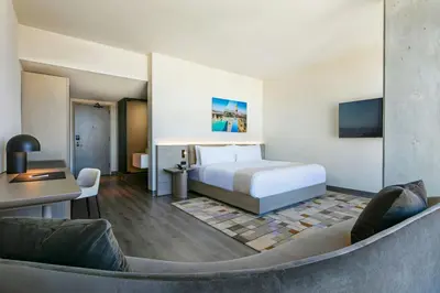 a hotel room with a bed and a couch at AC Hotel by Marriott Downtown Los Angeles in Los Angeles
