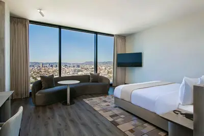 a hotel room with a bed and a couch at AC Hotel by Marriott Downtown Los Angeles in Los Angeles