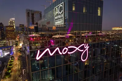a neon sign on the side of a building at AC Hotel by Marriott Downtown Los Angeles in Los Angeles