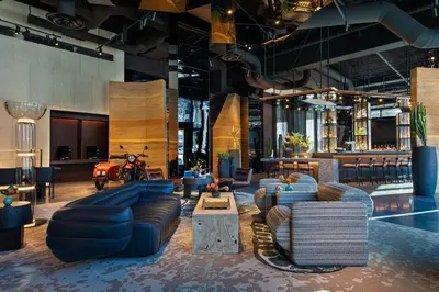 a lobby with couches and a motorcycle in a building at Moxy Downtown Los Angeles in Los Angeles