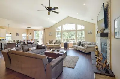 a large living room with couches and a fireplace at Lake Arrowhead Getaway with Decks and Game Room! in Lake Arrowhead