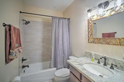 a bathroom with a tub and a sink and a toilet at Lake Arrowhead Getaway with Decks and Game Room! in Lake Arrowhead