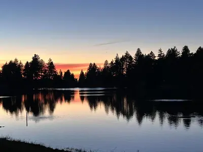 a lake with trees and a sunset in the background at Snow Bunny Cottage, Pets Welcomed! in Green Valley Lake