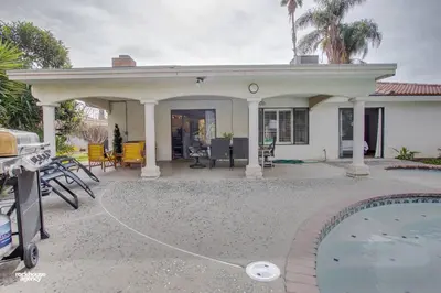 a house with a pool in front of it at Cozy Hygge Home Centrally Located 2 King Beds in Bakersfield