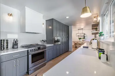 a kitchen with blue cabinets and a sink and a stove at #Marbella Lane - Cozy Modern Home with Relaxing Design & Pool in Fullerton