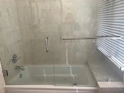 a bathroom with a tub with a glass shower door at HighEnd Rooms in Mansion in Riverside