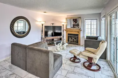 a living room with two couches and a fireplace at Bright California Home with Patio Less Than 1 Mi to Hiking! in Corona