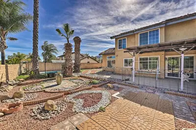 a home with a garden in front of a house at Bright California Home with Patio Less Than 1 Mi to Hiking! in Corona