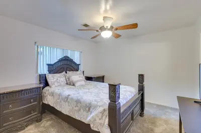 a bedroom with a bed and a ceiling fan at Convenient Bakersfield Townhome with Patio! in Bakersfield