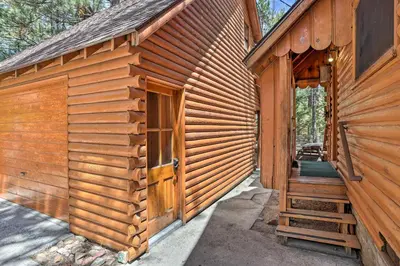 a wooden cabin with a door on the side of it at Big Bear Lake Cabin about 4 Mi Snow Summit Ski Resort in Big Bear Lake