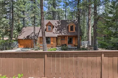 a log home with a fence and trees at Big Bear Lake Cabin about 4 Mi Snow Summit Ski Resort in Big Bear Lake