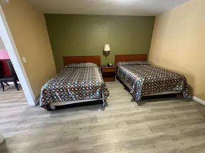 a room with two beds in a room at Desert Inn Motel in Corona