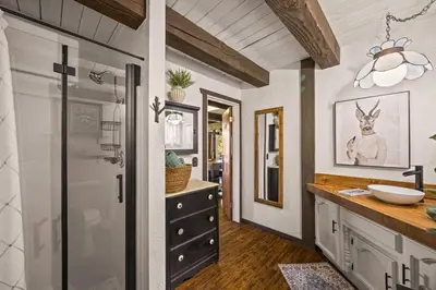 a bathroom with a sink and a mirror at The Lake Chalet in Crestline