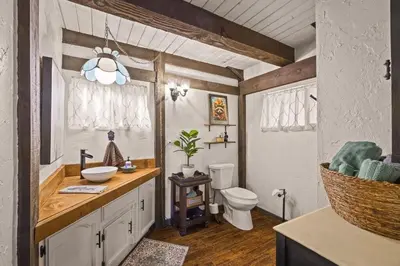 a bathroom with a sink and a toilet in it at The Lake Chalet in Crestline