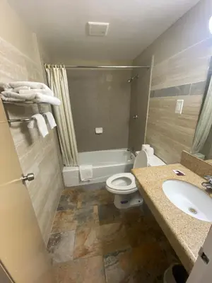 a bathroom with a toilet and a sink at Downtown Motel 7 in San Bernardino