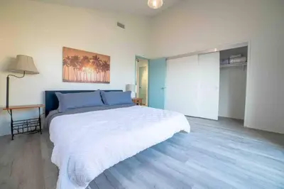 a bedroom with a large white bed in a room at Ocean View / Pool Table / Surfboards / Beach Bikes in Oxnard
