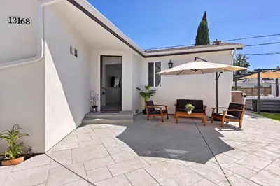 a patio with a table and an umbrella at Adorable 3 bedroom with Jacuzzi & more in Los Angeles