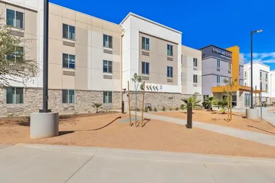an empty street in front of a building at Everhome Suites Corona in Corona