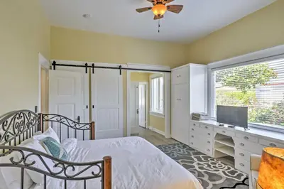 a bedroom with a bed and a desk and a television at Carpinteria Apt with Hot Tub - 10 Min Walk to Beach! in Carpinteria