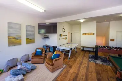 a living room with a pool table and ping pong ball at TheStellarJayChalet Lake View! in Lake Arrowhead