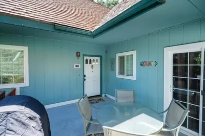 a blue room with a glass table and chairs at TheDragon's Den Mega Cabin Sleeps 12 in Lake Arrowhead