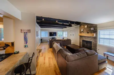 a living room with a couch and a fireplace at TheDragon's Den Mega Cabin Sleeps 12 in Lake Arrowhead