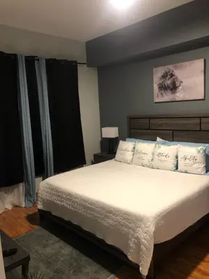 a bedroom with a bed with white sheets and pillows at 2 Bed Ocean View Balconys Corner Unit LB Convention Center in Long Beach
