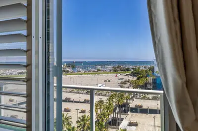 a view of the beach from a hotel room window at 2 Bed Ocean View Balconys Corner Unit LB Convention Center in Long Beach