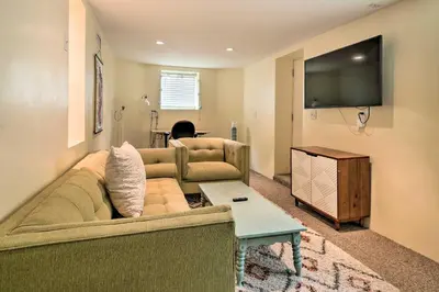 a living room with a couch and a flat screen tv at Charming Santa Paula Home - Walk to Downtown! in Santa Paula