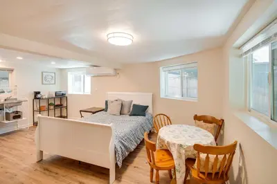 a bedroom with a bed and a table and chairs at Cozy Crestline Getaway about 2 Mi to Lake Gregory in Crestline