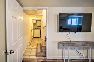 a hallway with a flat screen tv on a wall at Cozy Crestline Getaway about 2 Mi to Lake Gregory in Crestline