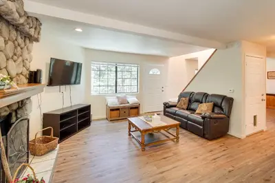 a living room with a couch and a fireplace at All-Season Crestline Escape - 2 Mi to Lake! in Crestline